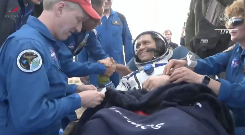 NASA astronaut Frank Rubio seated with NASA personnel nearby moments after extraction from the Soyuz spacecraft after landing